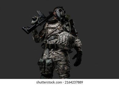 Studio Shot Of Black Military Man Holding Rifle On His Shoulder Isolated On Grey Background.