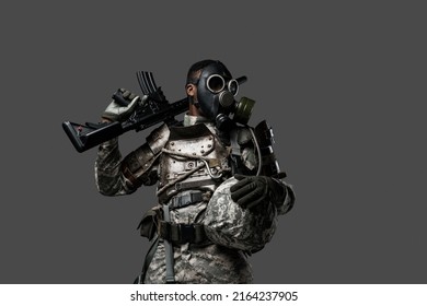 Studio Shot Of Black Military Man Holding Rifle On His Shoulder Isolated On Grey Background.