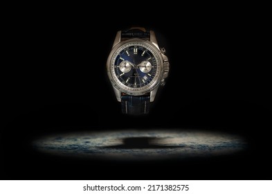 Studio shot of a blue fancy luxury unbranded Men watch on the black background. Stainless steel man's wrist watch with blue leather strap.