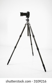 Studio Shot Of Camera And Tripod.