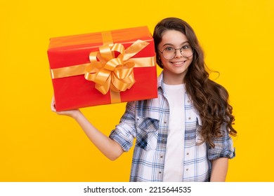 Studio Shot Of Cheerful Teen Kid Hold Present. Teen Kid Holding Box Of Present. Teen Kid