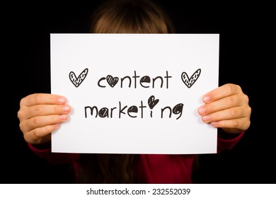 Studio Shot Of Child Holding A Content Marketing Sign Made Of White Paper With Handwriting.