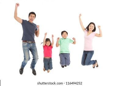 Studio Shot Of Chinese Family Jumping In Air