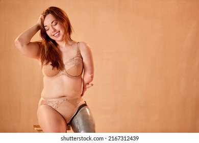 Studio Shot Of Confident Natural Woman With Prosthetic Limb In Underwear Promoting Body Positivity