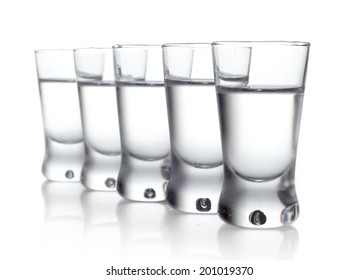 Studio Shot Of Five Glasses Of Vodka Isolated On White