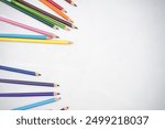 Studio shot of flatlay photo of kids coloring pencils on white background banner, copy space. Back to school concept.