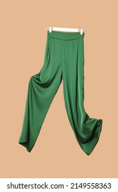 Studio Shot Of Floating Green Silk Trousers.