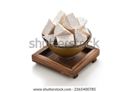 Studio shot of fresh taro and taro cubes on white background