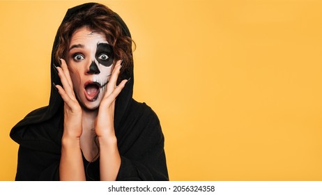 A studio shot of a girl expressing fright in a costume of evil spirits at a Halloween costume party. Empty space for goods, advertising. The Art of Halloween - Shutterstock ID 2056324358