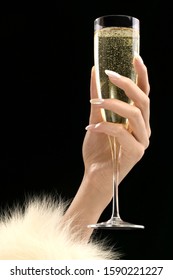 Studio Shot Of Woman’s Hand Holding Champagne Flute