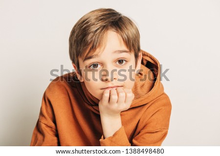 Similar – Image, Stock Photo Brown-haired boy with an athletic physique on an athletic oval massages his muscles with a foam roller for better recovery. Post-workout
