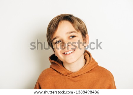 Similar – Image, Stock Photo Brown-haired boy with an athletic physique on an athletic oval massages his muscles with a foam roller for better recovery. Post-workout