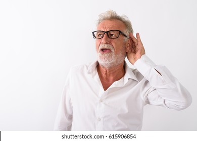 Studio shot of handsome senior bearded man listening while thinking and wearing eyeglasses against white background - Powered by Shutterstock