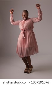 Studio Shot Of Happy African Woman Dancing