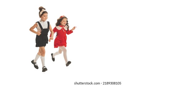 Studio Shot Of Little Happy Girls In Retro Style Outfit, Fashion Of 70s, 80s Years Isolated On White Background. Concept Of Emotions, Facial Expression, Beauty. Copy Space For Ad