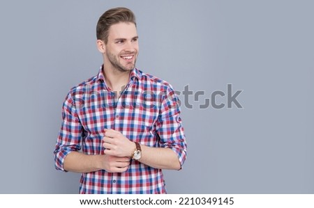 studio shot of man, copy space. caucasian man having stubble. handsome man in checkered shirt