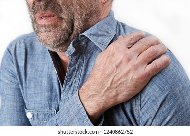 Studio Shot Of Man Suffering With Frozen Shoulder