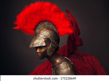 Studio shot of mannequin in armor and in helmet with feathers on head