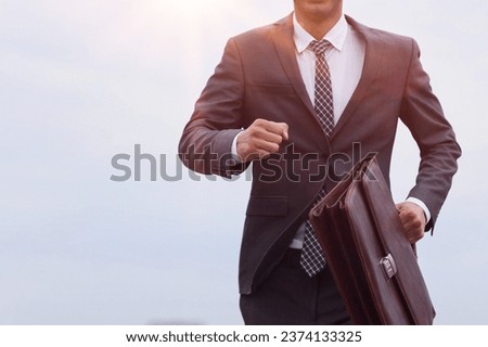 Studio shot of a mature businessman running with a briefcase iso