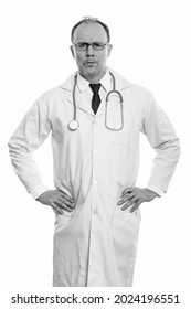 Studio shot of mature handsome Scandinavian man doctor isolated against white background in black and white