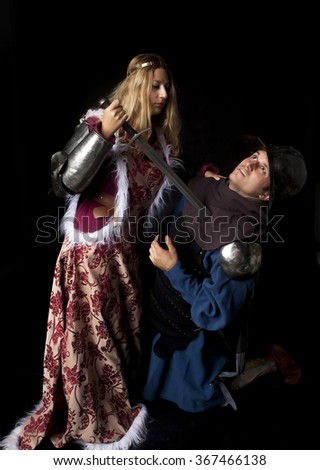 Studio shot of a medieval style scene with a beautiful noble princess killing a treacherous knight
