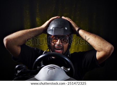 Studio shot of middle aged man who playing race video game.