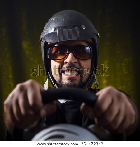 Studio shot of middle aged man who playing race video game.