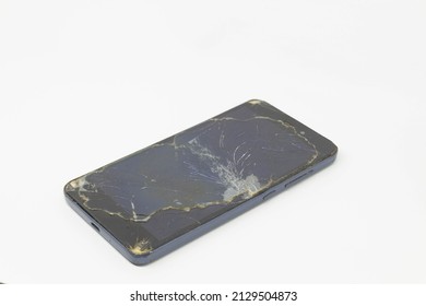studio shot of an Mobile Phone with seriously broken retina display screen isolated on white