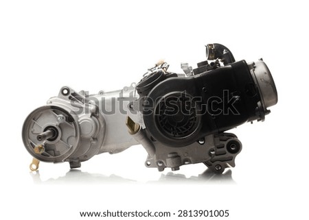 Studio shot of a new complete 4-stroke single-cylinder scooter engine assembly with CVT transmission isolated on a white background. Premium replacement GY6 or 139QMB type motor block featuring a cast aluminum crankcase with an extended variator housing showing the splined rear wheel output axle shaft, a heavy-duty black plastic forced-air cooling shroud system with a fan cover casing, an intake manifold pipe, and a gold-tone oil dipstick. High-key product photography with reflection.