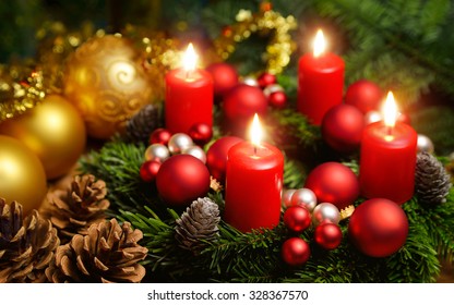 Studio shot of a nice advent wreath with baubles and four burning red candles