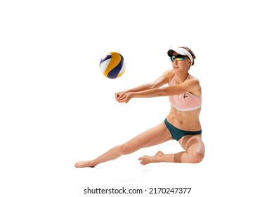 Studio shot of one fitness young woman, volleyball player in sports swimsuit playing beach volleyball isolated on white background. Sport, healthy lifestyle, team, fitness concept.