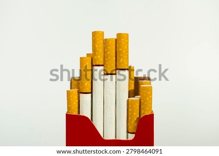 Studio shot of partially full red pack of cigarettes with cigarette addiction nicotine unhealthy abstinence lifestyle