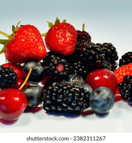 Studio shot photo of dark berries juicy tasty berry medley assortment mixed