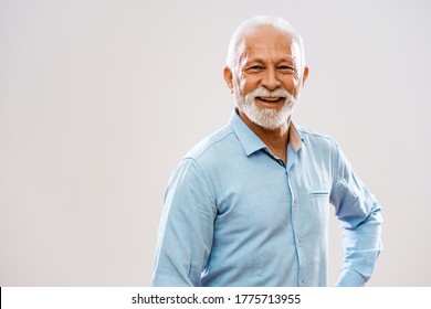 Studio Shot Portrait Of Cheerful Senior Man.