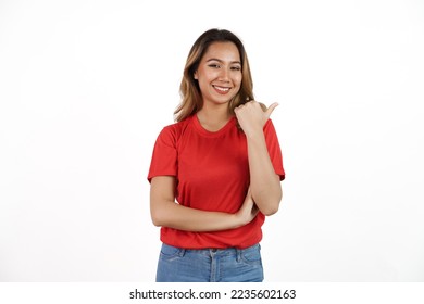 Studio shot of pretty Asian woman with red t-shirt isolated on white background. Pointing blank area - Shutterstock ID 2235602163