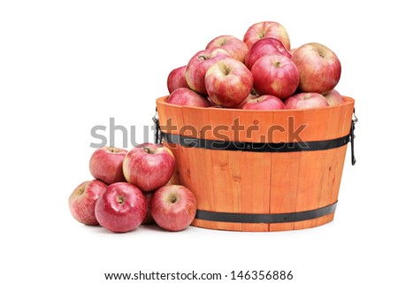 Studio shot of red apples in a wooden bucket isolated on white background