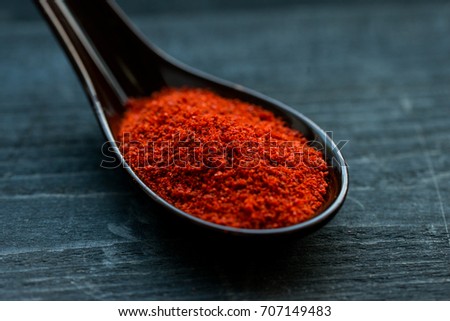 Studio shot of red paprika powder in spoon