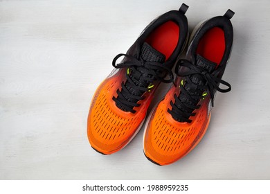 A Studio Shot Of Running Shoes Orange On White Background. Top View