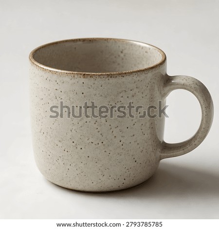 Studio shot of rustic ceramic mug with speckled pattern textured surface simple design for cozy morning coffee beverages.