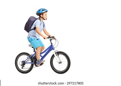 Studio Shot Of A Schoolboy With A Helmet And A Blue Backpack Riding A Bike Isolated On White Background