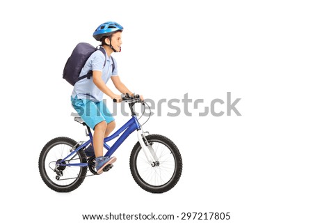 Studio shot of a schoolboy with a helmet and a blue backpack riding a bike isolated on white background