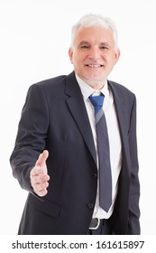 Studio Shot Of A Senior Businessman Offering A Handshake.