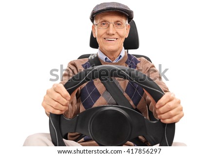 Studio shot of a senior driver holding a steering wheel and looking at the camera isolated on white background