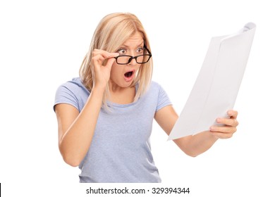 Studio Shot Of A Shocked Woman Looking At The Bills In Disbelief Isolated On White Background