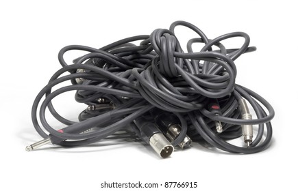 studio shot showing a clew of dark audio cables in white back, with clipping path