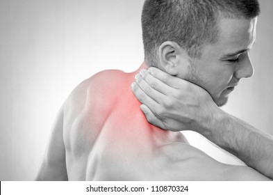 Studio Shot Of Sportsman With Pain In Neck