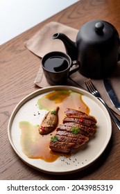 Studio Shot For A Steakhouse Restaurant, Top View Of A Hot Steak On A Dark Wooden Table