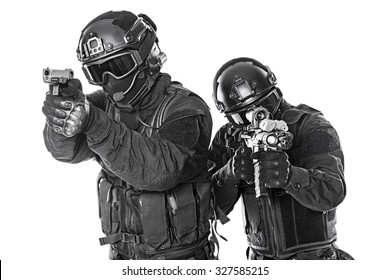 Studio Shot Of Swat Police Special Forces Black Uniforms Aiming Terrorists Automatic Rifle. Tactical Helmet Vest Goggles. Isolated On White Side View