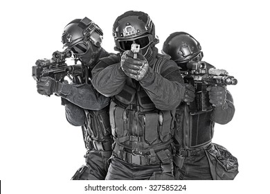 Studio Shot Of Swat Police Special Forces Black Uniforms Pointing Terrorists Pistol Automatic Rifle. Tactical Helmet Vest Goggles. Isolated On White