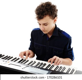 Studio Shot Of Teenager Playing An Electronic Piano, Isolated Over White Background